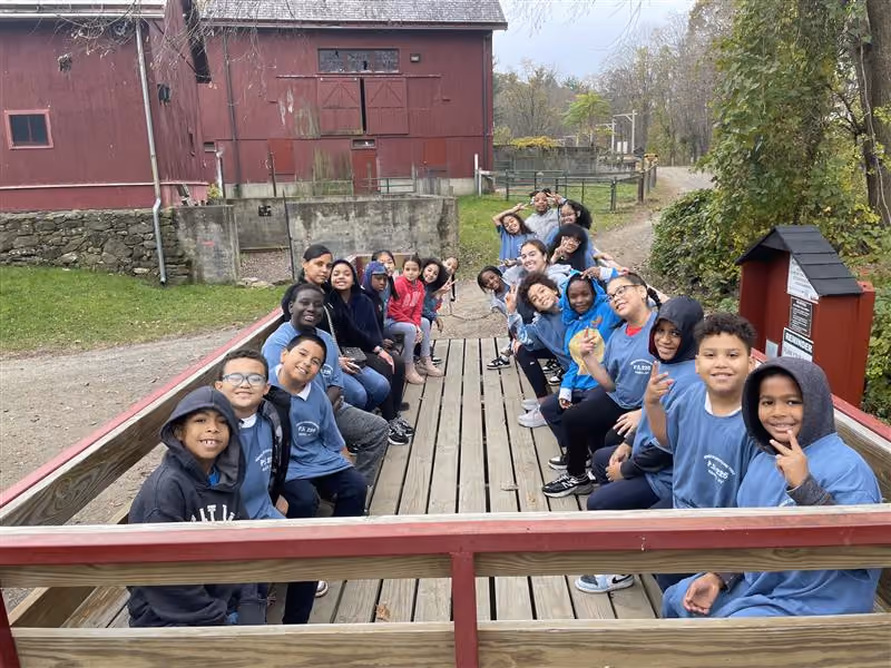 Students on a hayride wagon during a farm field trip