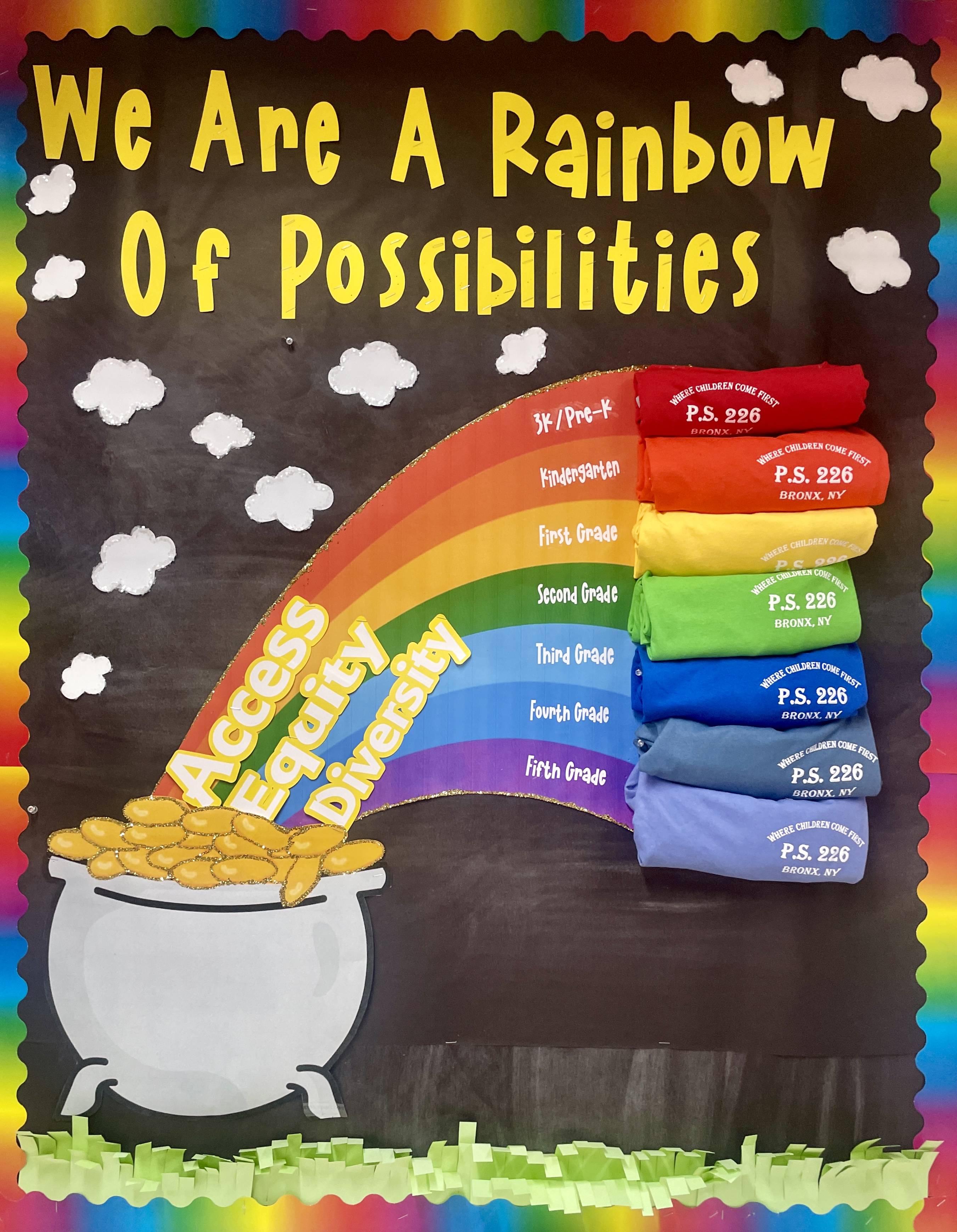 Rainbow bulletin board displaying P.S. 226 grade-level shirts promoting access equity and diversity