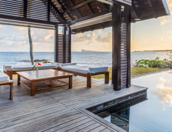 A luxurious private villa in Mauritius with an infinity pool overlooking a pristine beach.