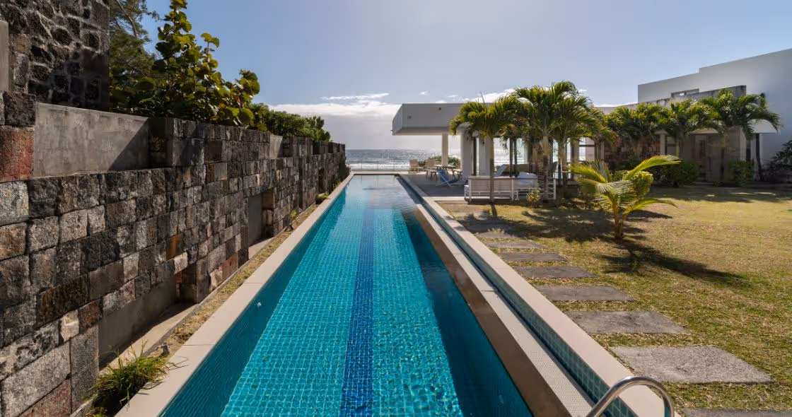 A luxurious villa in Mauritius with a private infinity pool overlooking a pristine beach.