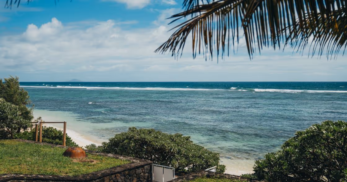 A stunning luxury villa in Mauritius with a private infinity pool, beachfront views, and lush surroundings, perfect for an exclusive retreat.