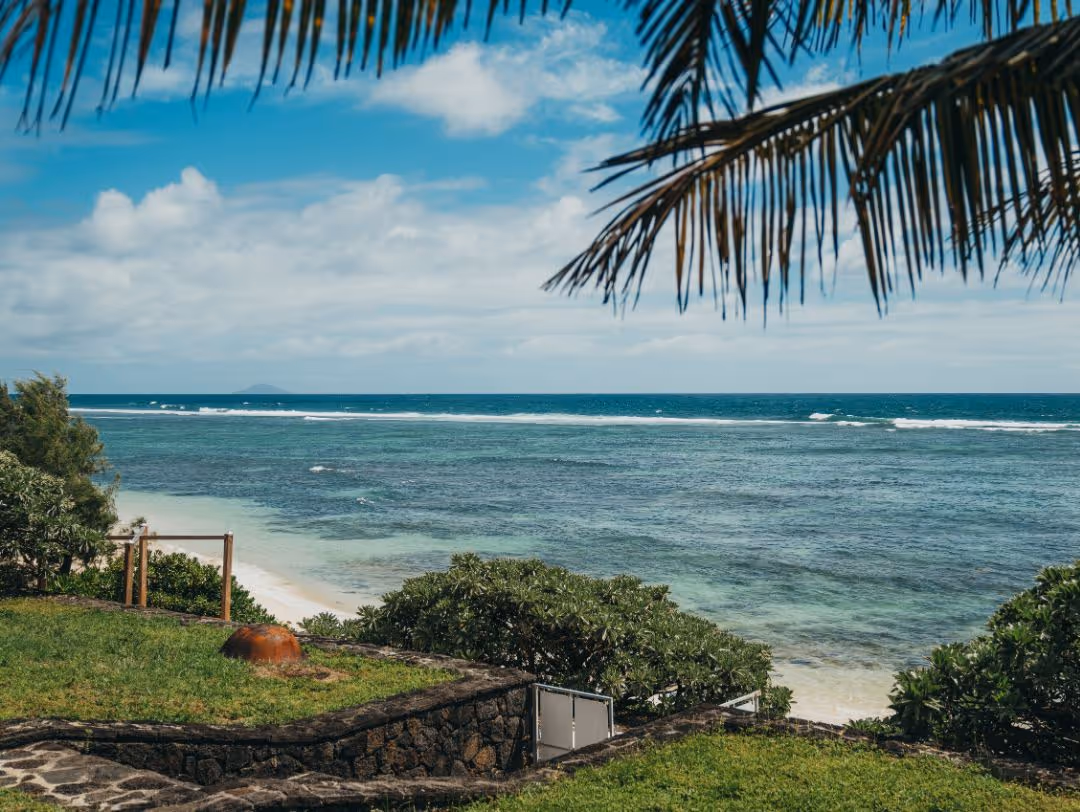A stunning luxury villa in Mauritius with a private infinity pool, beachfront views, and lush surroundings, perfect for an exclusive retreat.