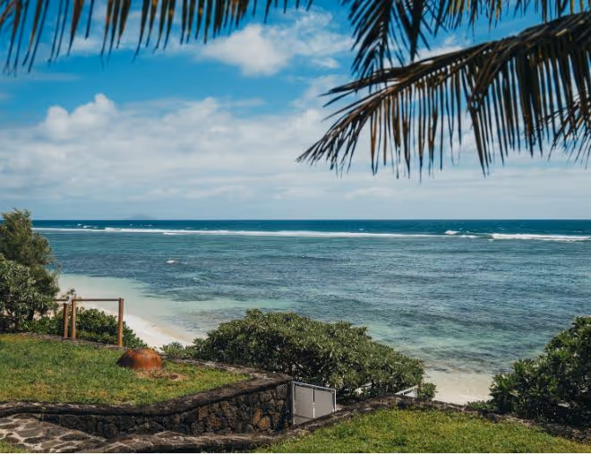 A stunning luxury villa in Mauritius with a private infinity pool, beachfront views, and lush surroundings, perfect for an exclusive retreat.
