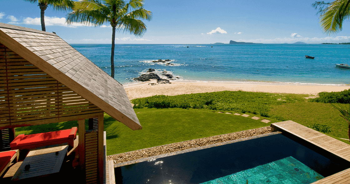 Beachfront villa with private pool, palm trees, and ocean view