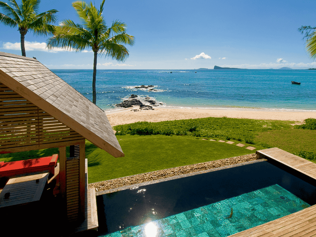 Beachfront villa with private pool, palm trees, and ocean view