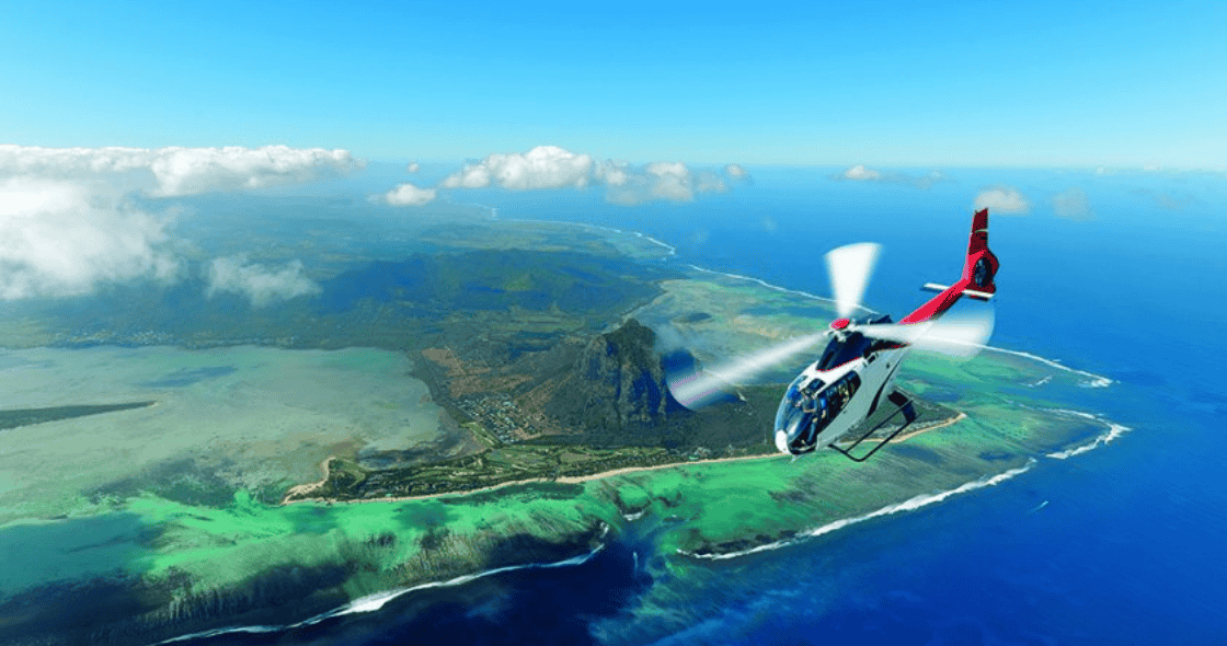Helicopter sightseeing tour over the tropical coast and blue waters of Mauritius.