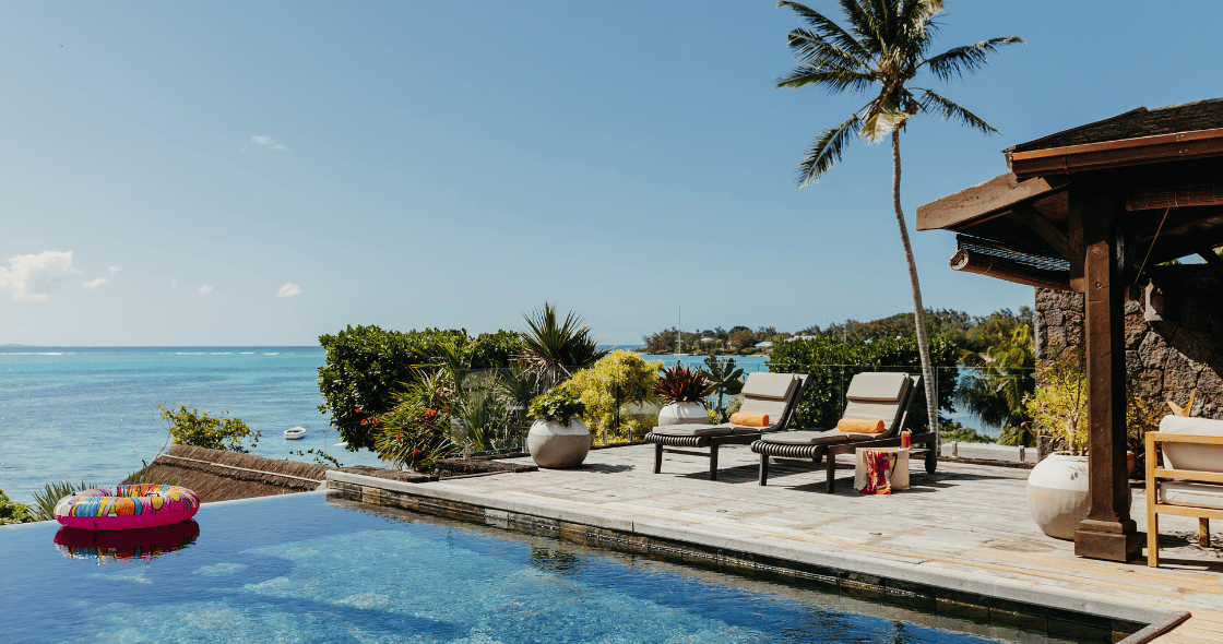 Relax by a paradise-style swimming pool at a beachfront property in Mauritius during an October summer holiday.