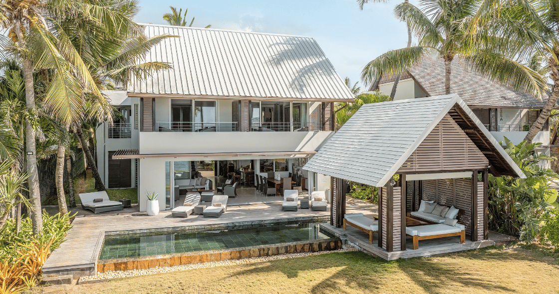 Couple relaxing by a secluded swimming pool at a luxury villa on Mauritius’ east coast during summer