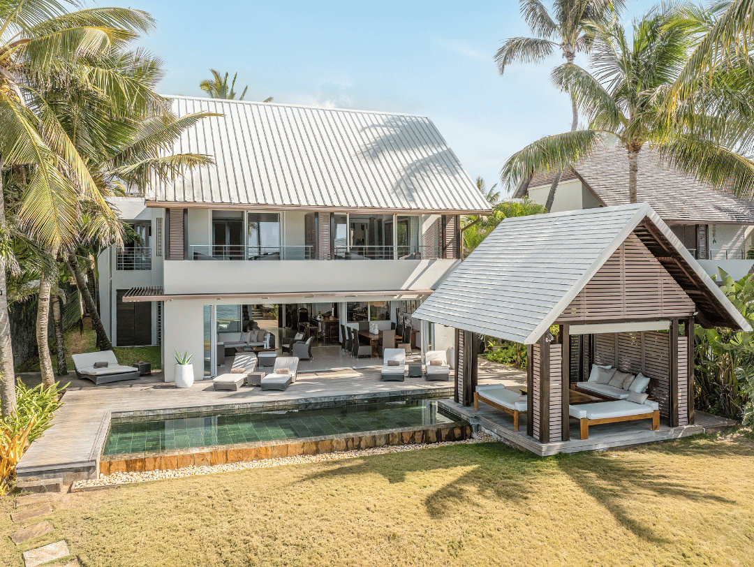 Couple relaxing by a secluded swimming pool at a luxury villa on Mauritius’ east coast during summer