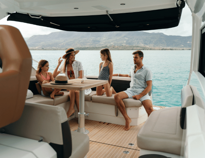 Family members bond and unwind on the deck of a yacht off the eastern shores of Mauritius.