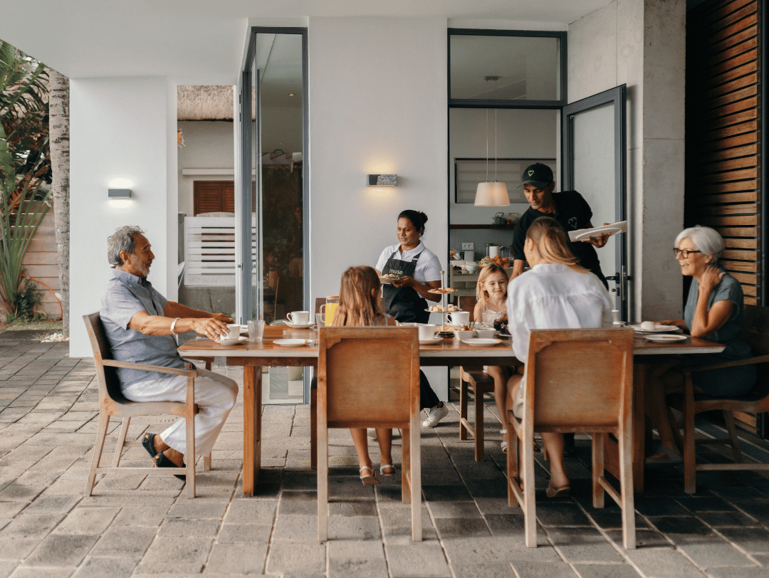 Family of multiple generations having a gourmet breakfast at a luxury holiday villa by Muse Villas.