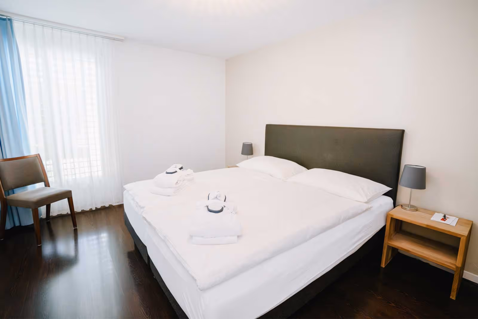 Chambre avec lit double, chaise et table de nuit