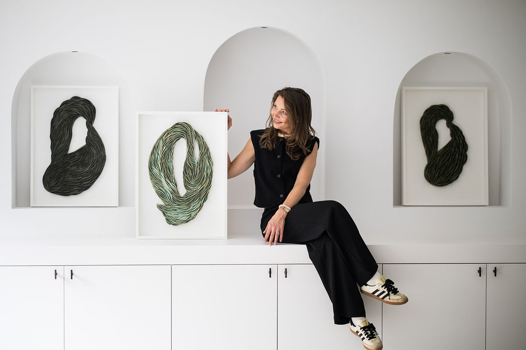 Mural green ceramic composition by french artist Lorene Cavagna, composed of thin, curved clay layers that rise and flare outward in an undulating organicshpe. One of a kind. French artist Lorène Cavagna is a ceramist who delves into movement and repetition through her research on glazes. Lorene Cavagna began her ceramic journey in London, where she earned her degree. Two years later, she returned to France, establishing her ceramic workshop in Metz, where she works with stoneware and porcelain.