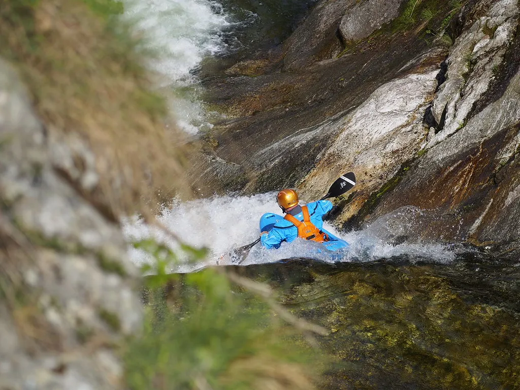 A kayaker dropping into the sorba slides rapid in Italy