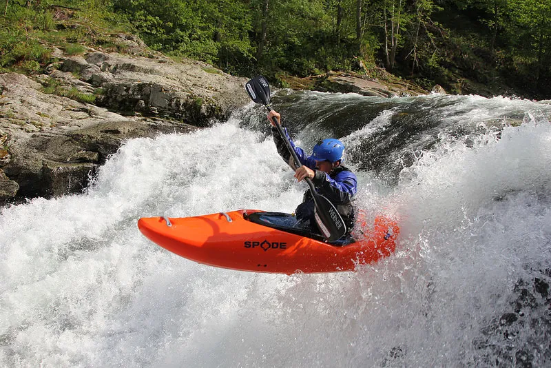 A kayaker showing how to boof a feature