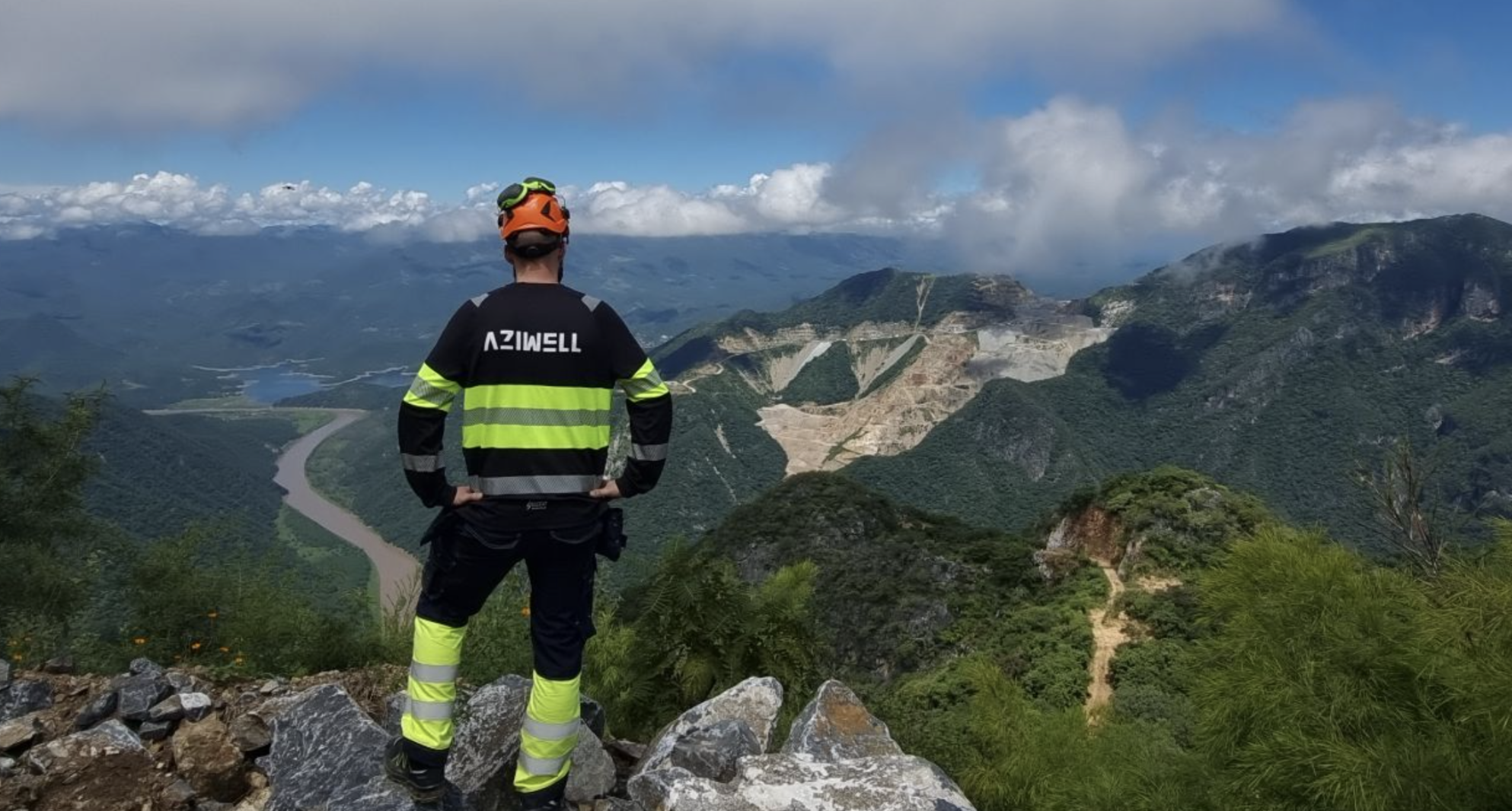 Aziwell technician overlooking an open-pit mining operation.