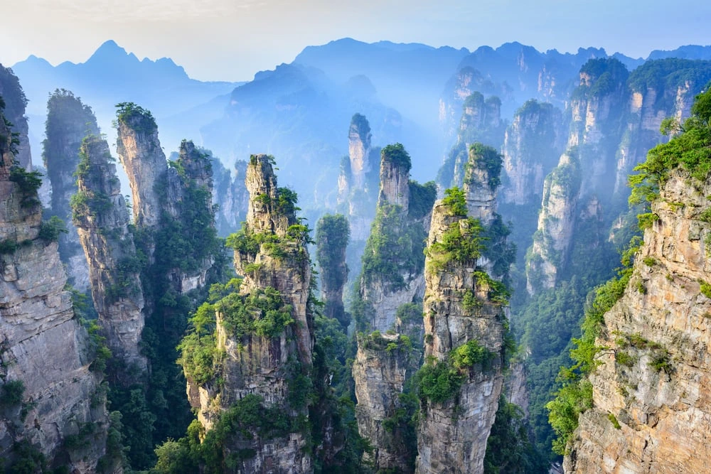 Fly to Guilin, where a private transfer takes you to the Shangri-La Hotel for a two-night stay. Settle into your elegant suite with views of the Li River, framed by Guilin`s iconic limestone karsts. The afternoon is yours to relax and absorb the serene beauty of southern China. In the evening, indulge in the hotel`s refined dining options, preparing for tomorrow`s journey along the Li River and through the breathtaking landscapes of Yangshuo.