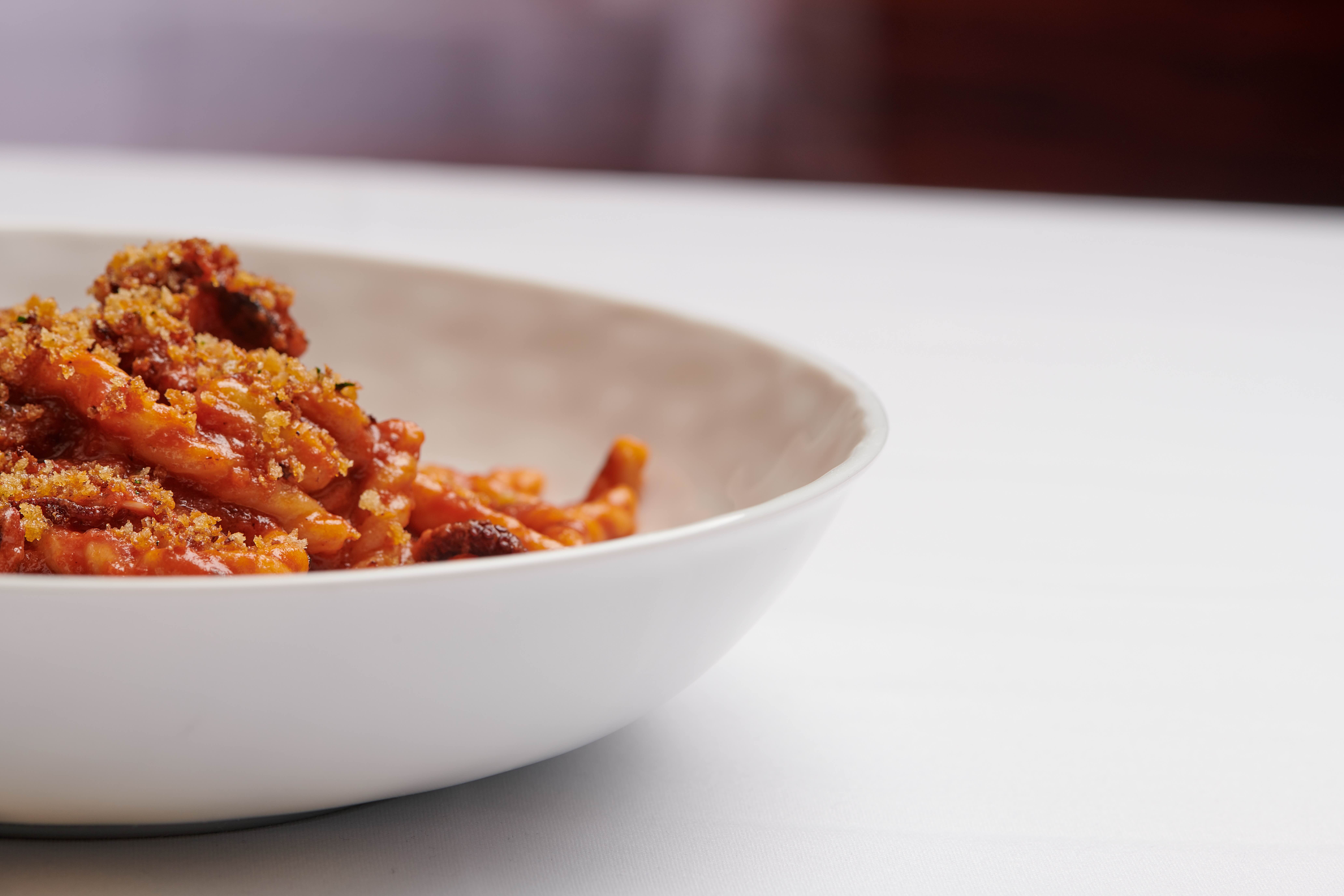 a white bowl full of pasta
