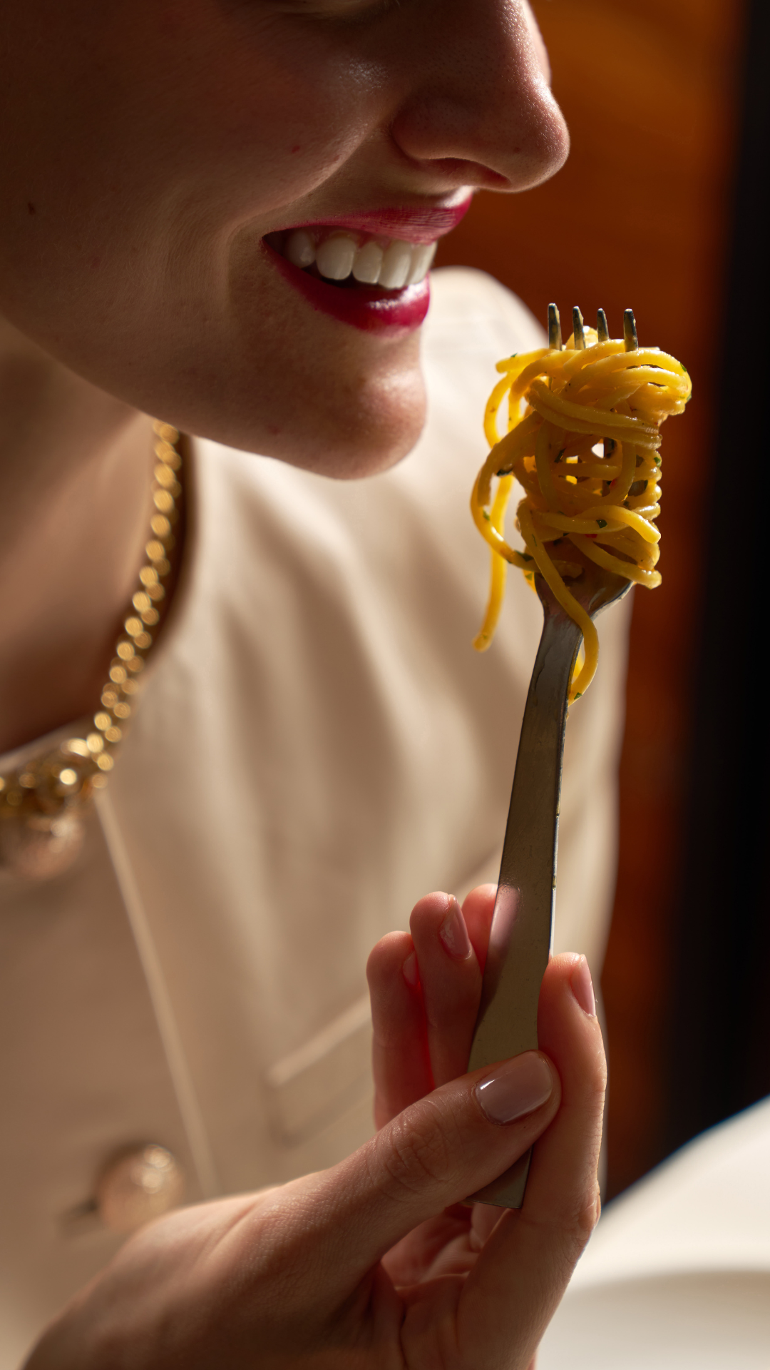 A refined coastal Italian table setting featuring a sparkling rosé cocktail being topped with Champagne, surrounded by elegantly plated dishes including grilled langoustines, crudi, fresh avocado, olive oil, and artisanal bread on a white tablecloth—capturing the elevated dining experience of Marea.