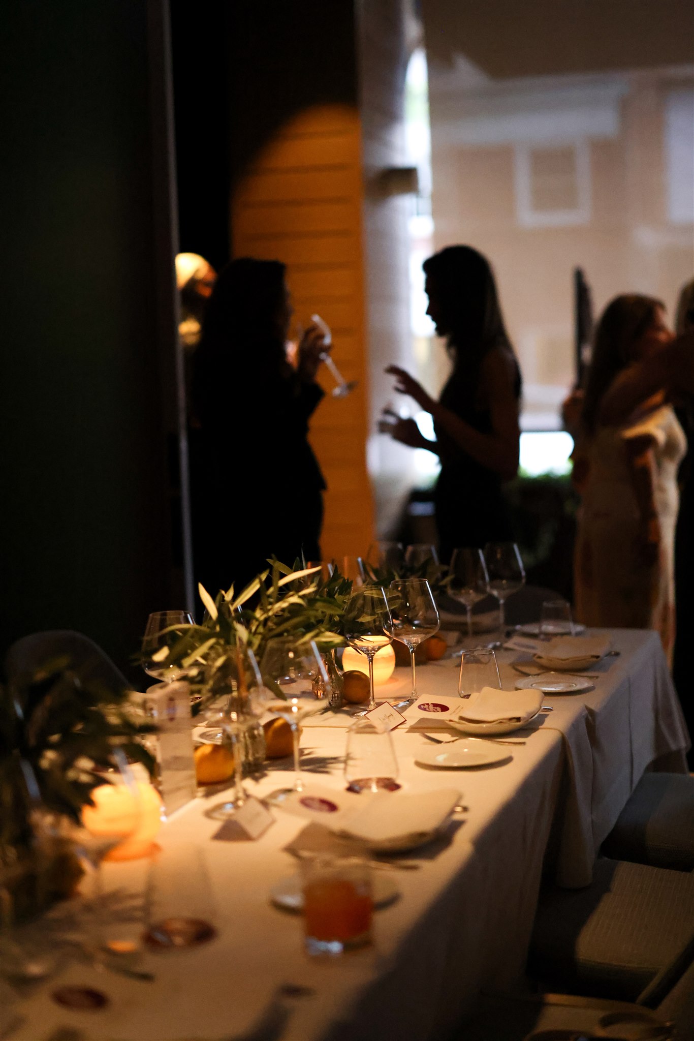 marea beverly hills' positano private dining room - a long table with white tablecloths leads to a large window