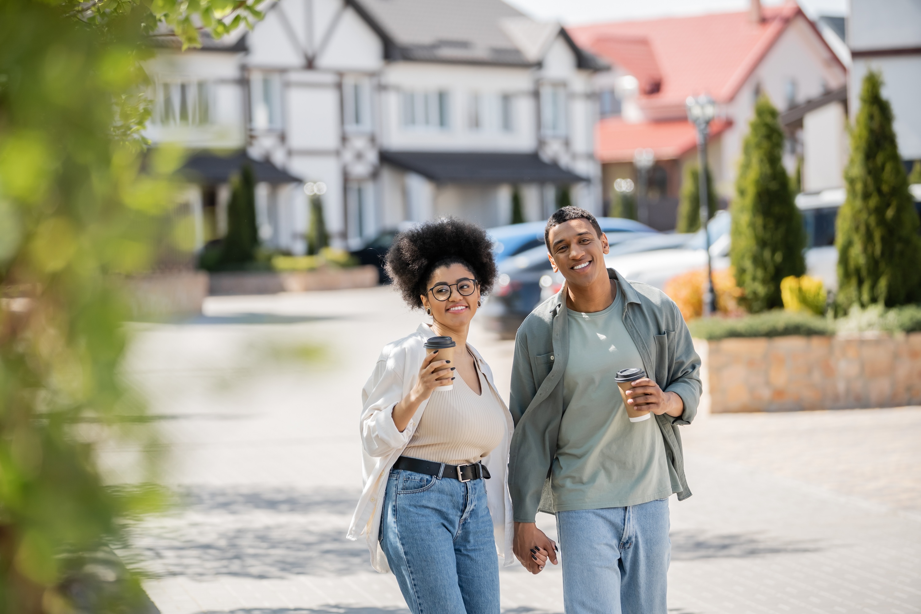 Residents walking through the apartment community holding coffee cups near The Abbey in Greenville, SC