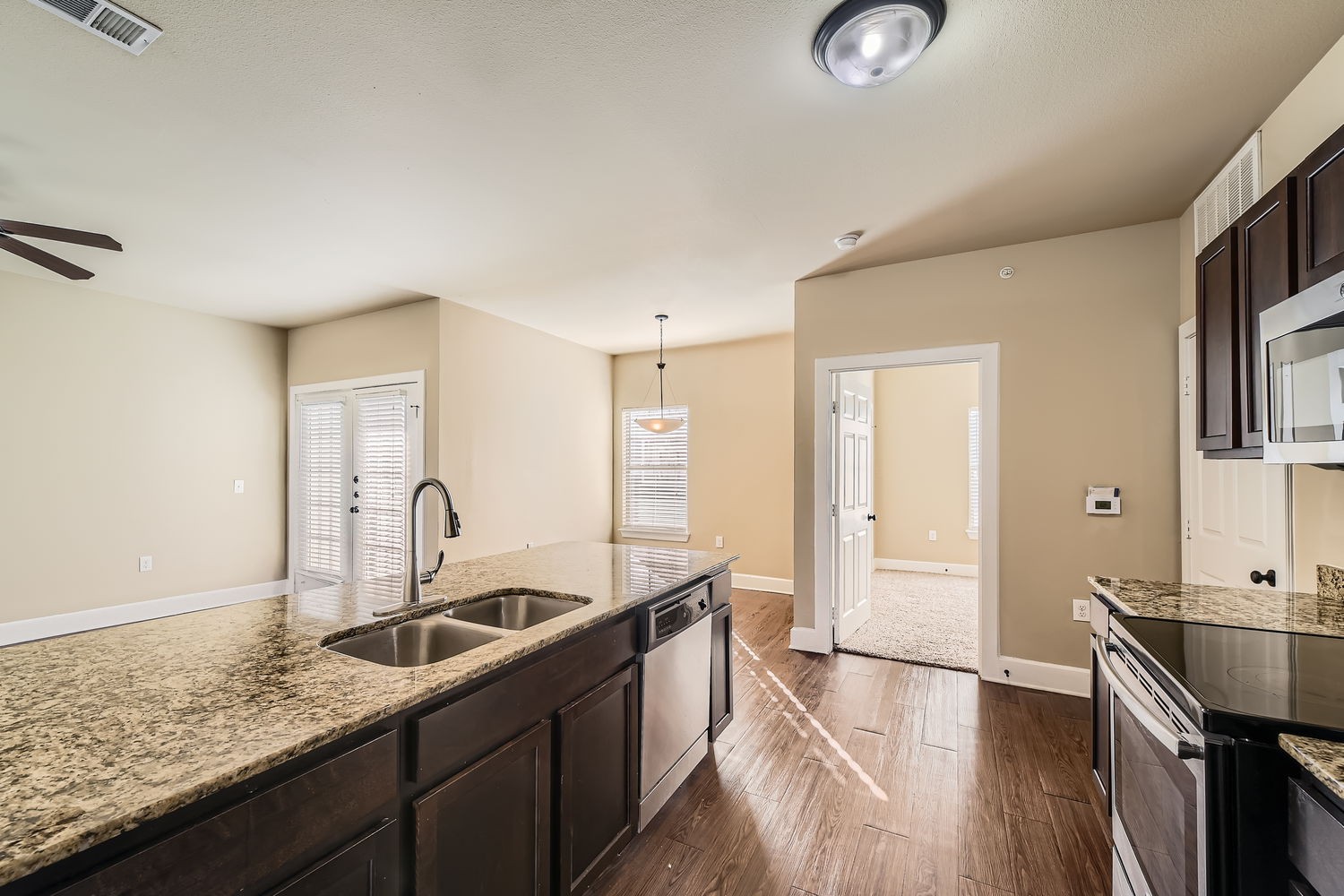Empty kitchen with brown cabinets