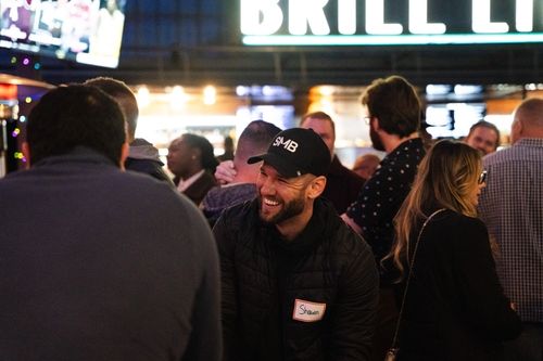 Shawn laughing at a networking event