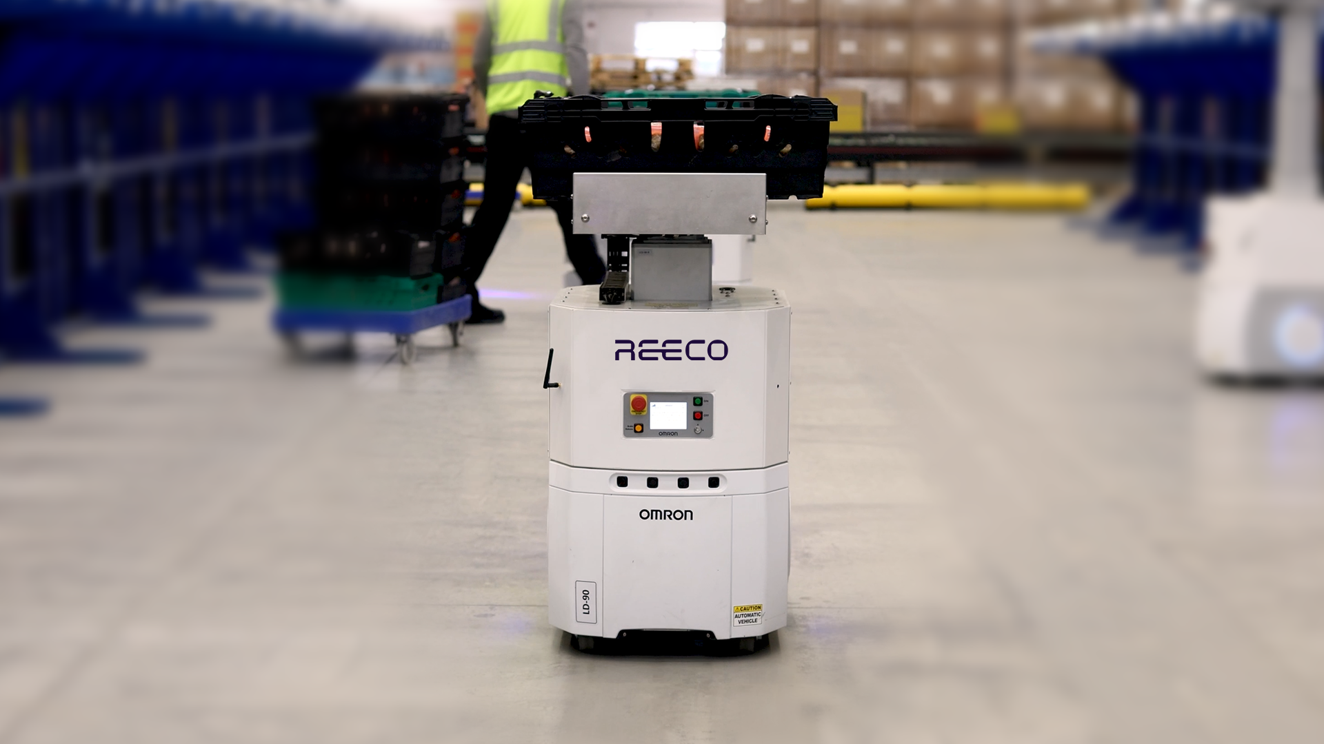 Reeco autonomous mobile robot (AMR) transporting goods in a warehouse