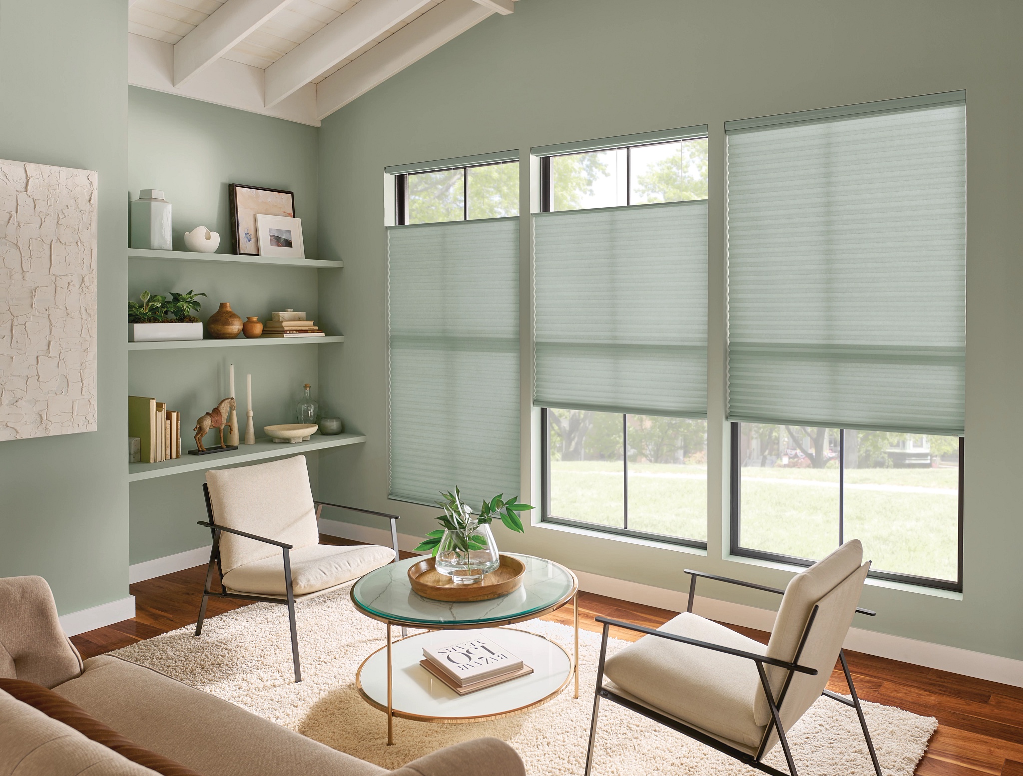 Graber cellular shades in a sage green living room
