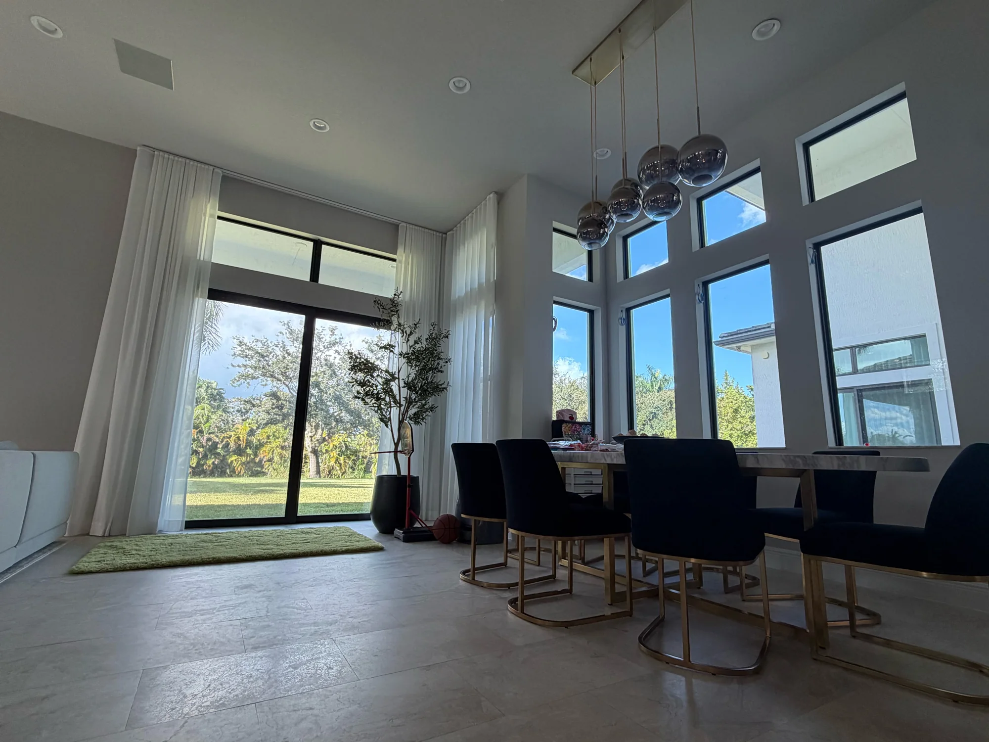 Tall white sheer drapery seen from the dining area.