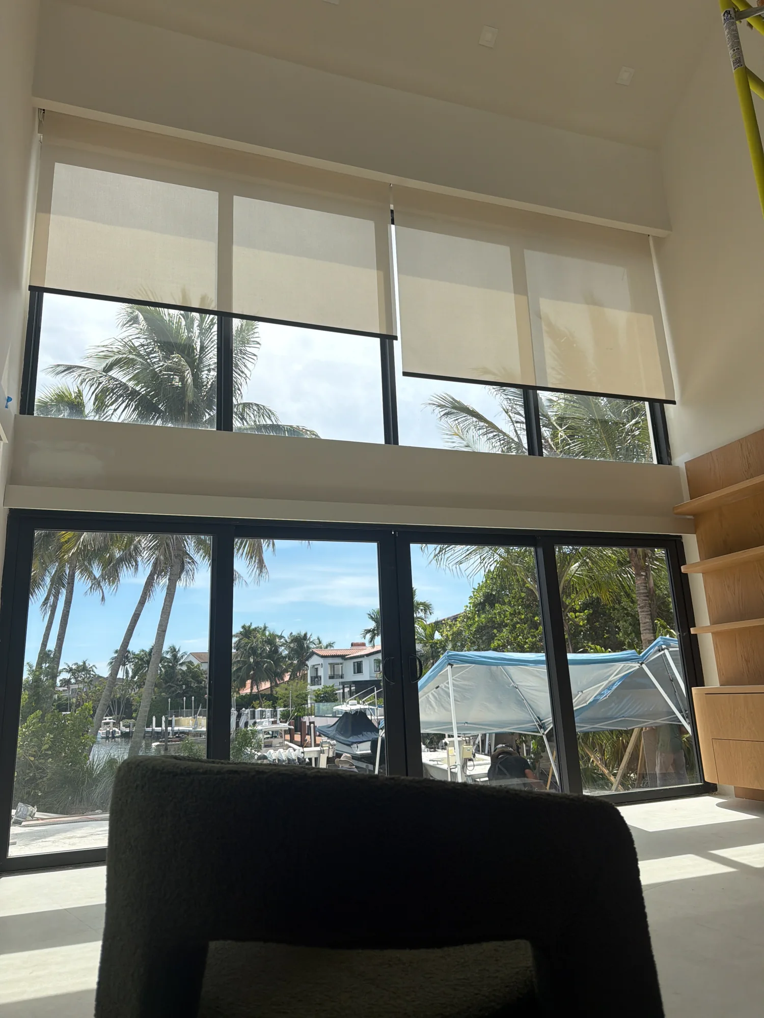 Tall roller shades during on-site installation review.