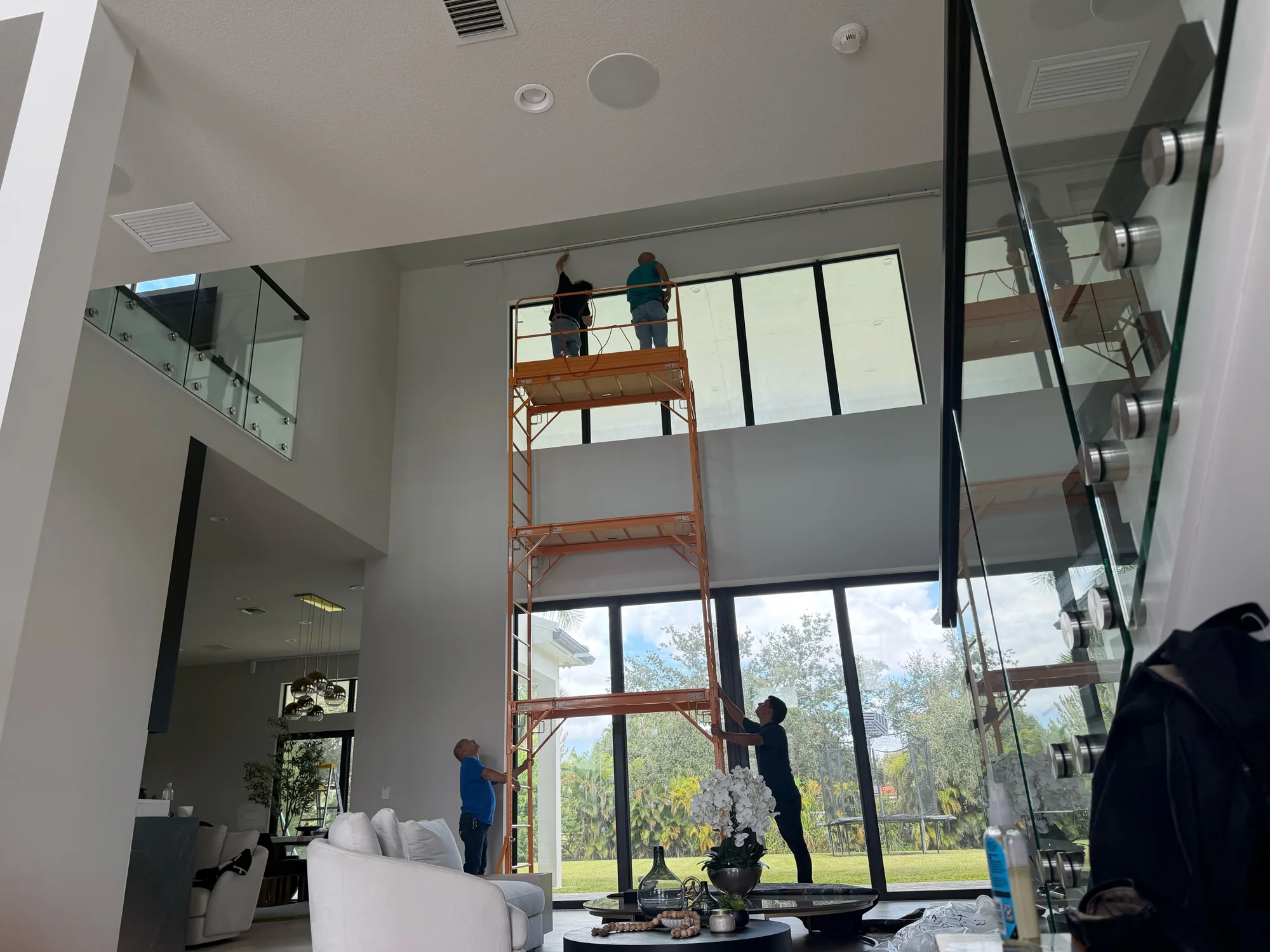 Installation work at the double-height window wall.