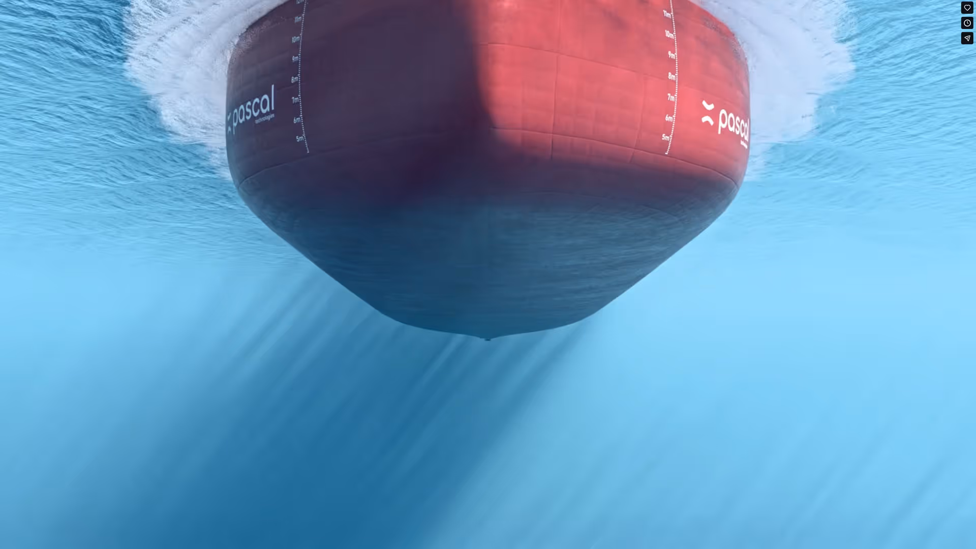 Underwater view of the bow of a large red ship named Pascal moving through clear blue water.
