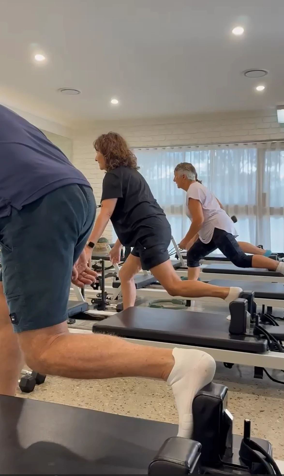 Better Bones group exercise class doing reformer lunges at the Ferny Hills clinic