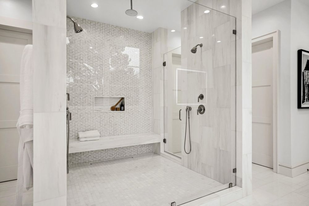 Luxury walk-in shower with premium tile, glass enclosure, and spa-inspired finishes