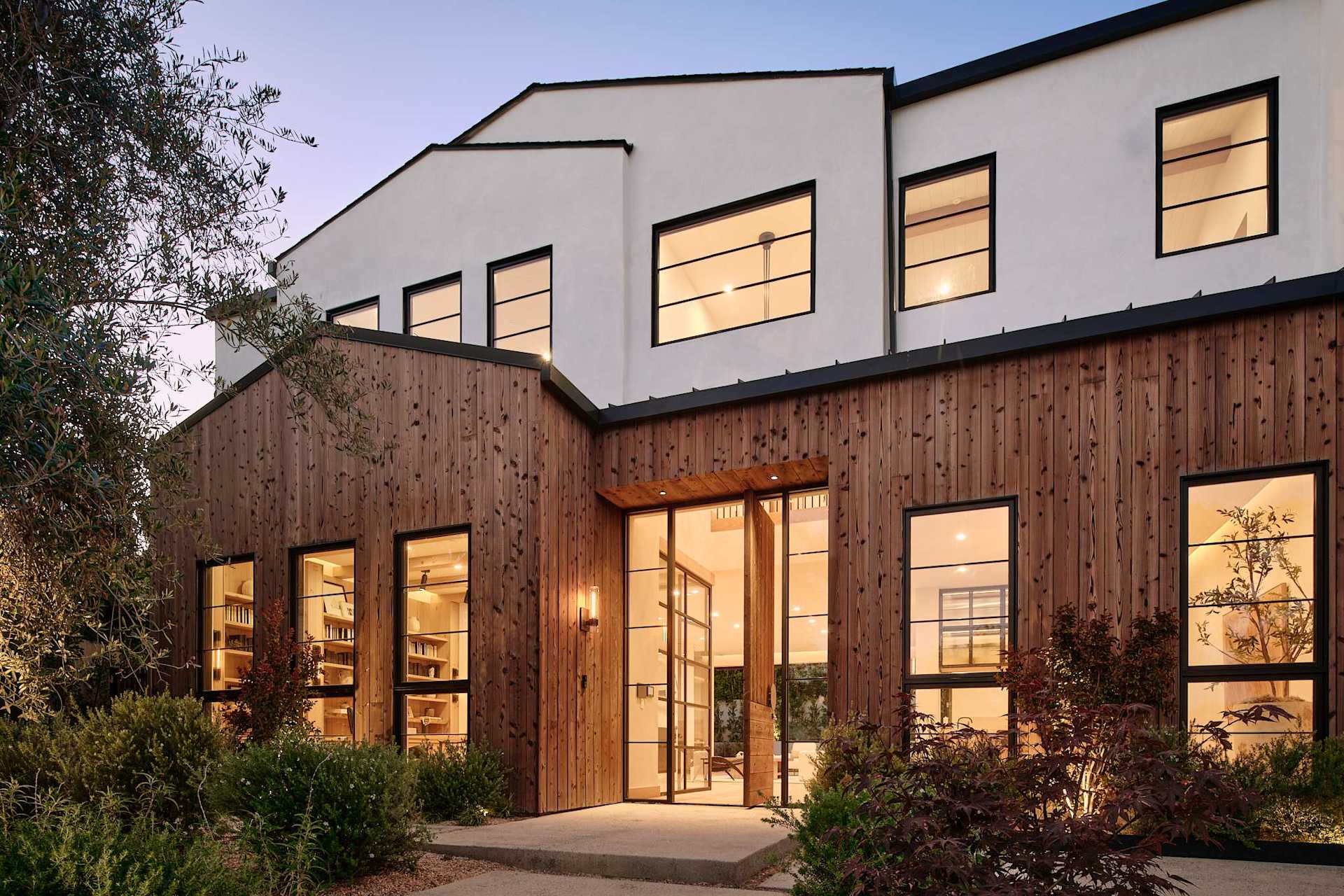 Modern two-story home addition with landscaped entry and premium finishes
