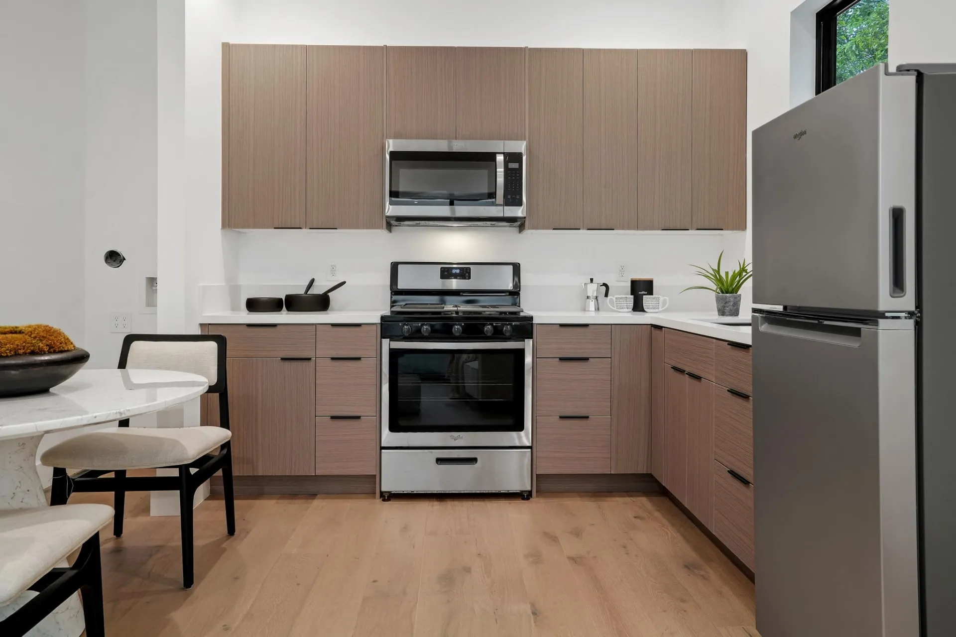 Premium kitchen cabinetry with clean lines, stone countertops, and custom storage