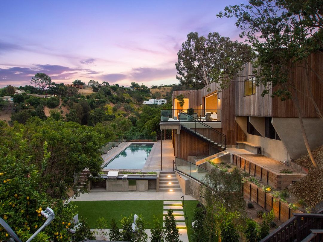 Steel stair and stepped concrete retaining walls at dusk below a hillside home on Dixie Canyon Ave, Sherman Oaks