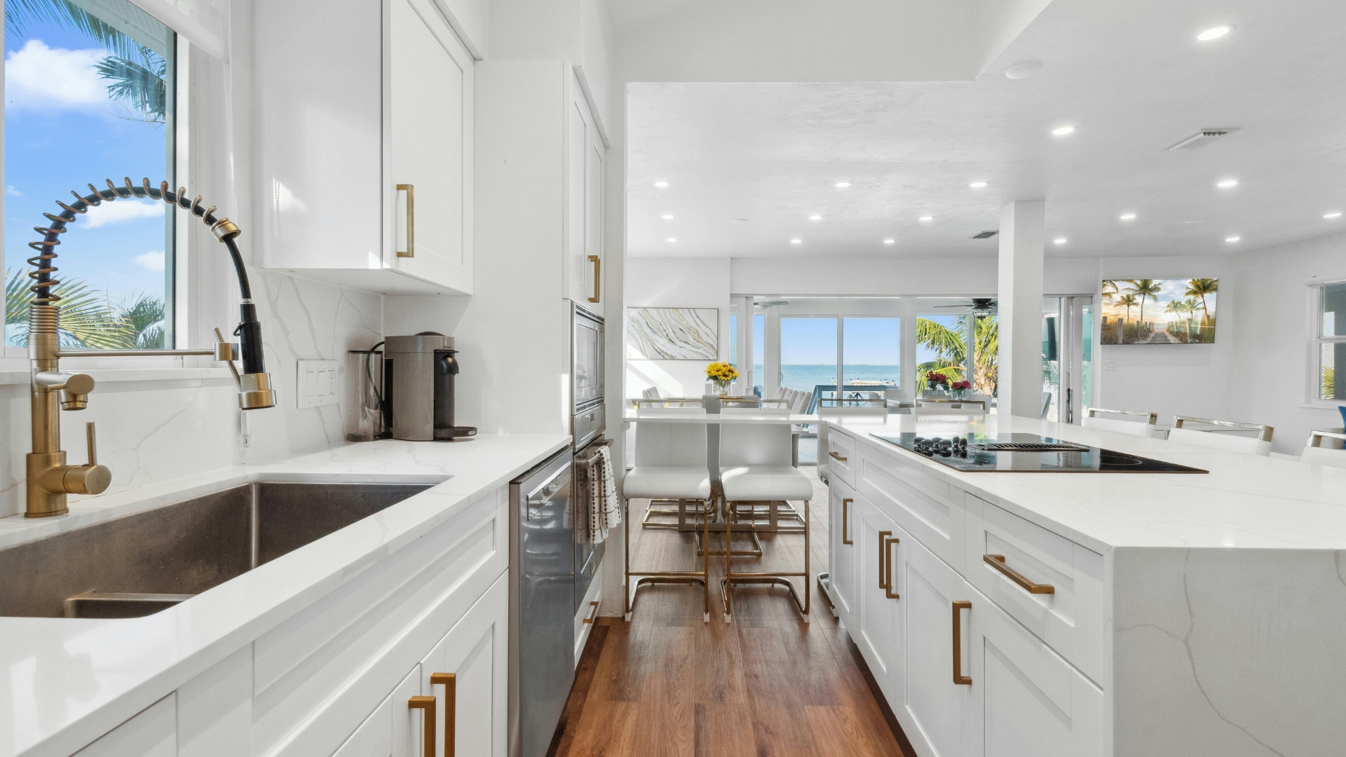 Contemporary kitchen layout in Malibu featuring a large island, recessed lighting, and gold faucet accents
