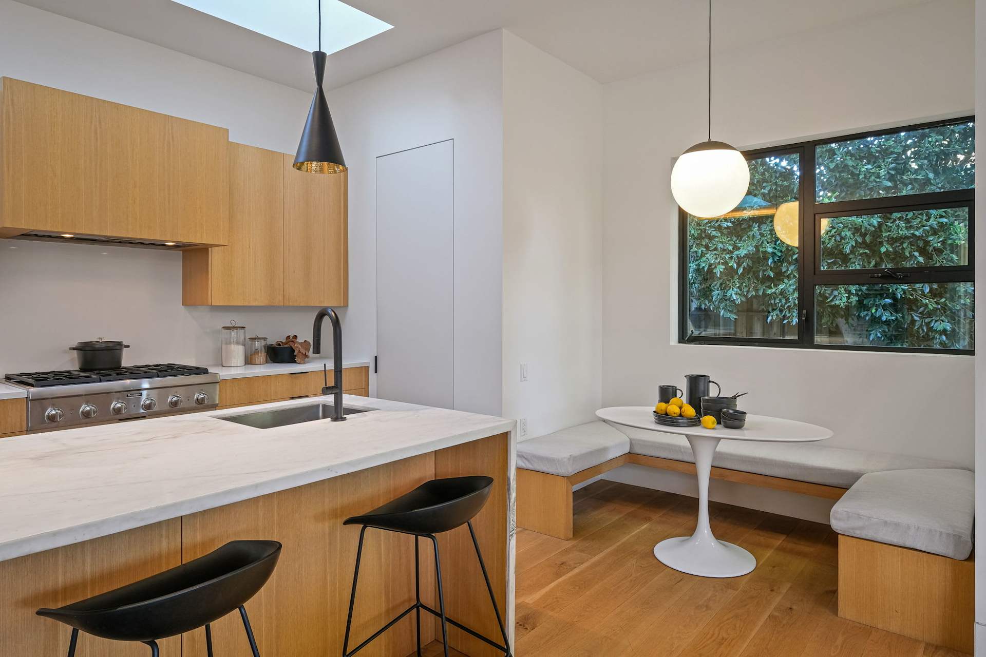 Kitchen breakfast nook with built-in bench seating and modern finishes.