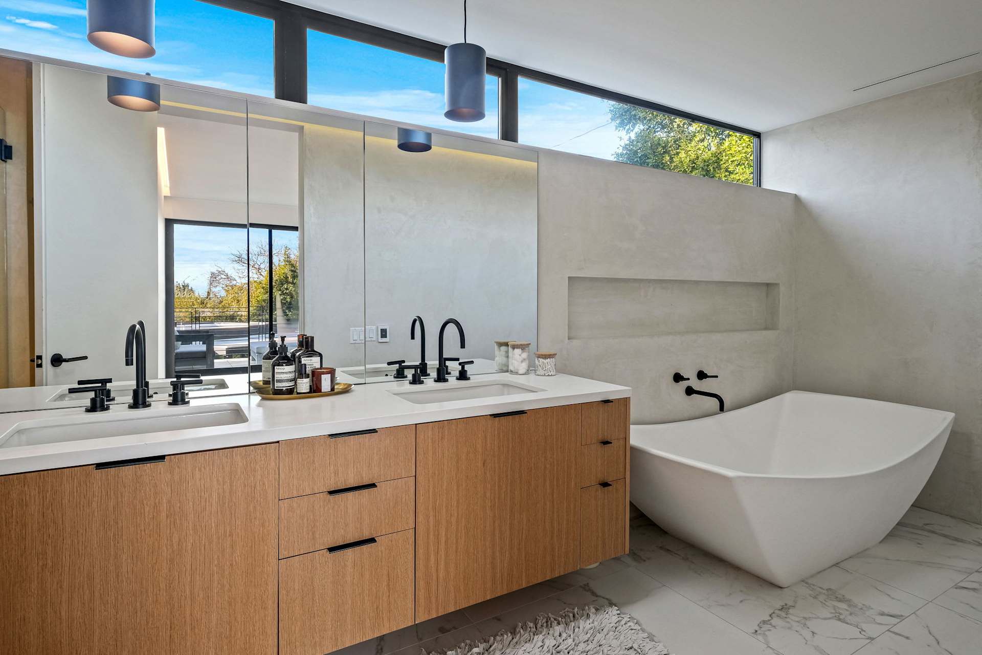 Primary bathroom with a double vanity and a freestanding tub.