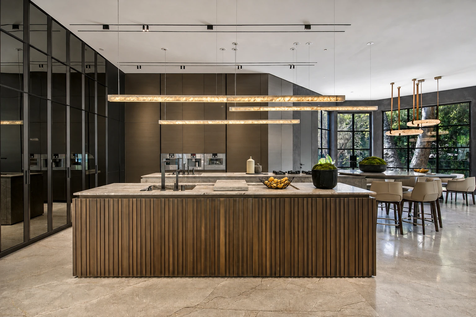 Kitchen at Benedict Canyon with a ribbed island, full-height cabinetry and suspended linear lights.