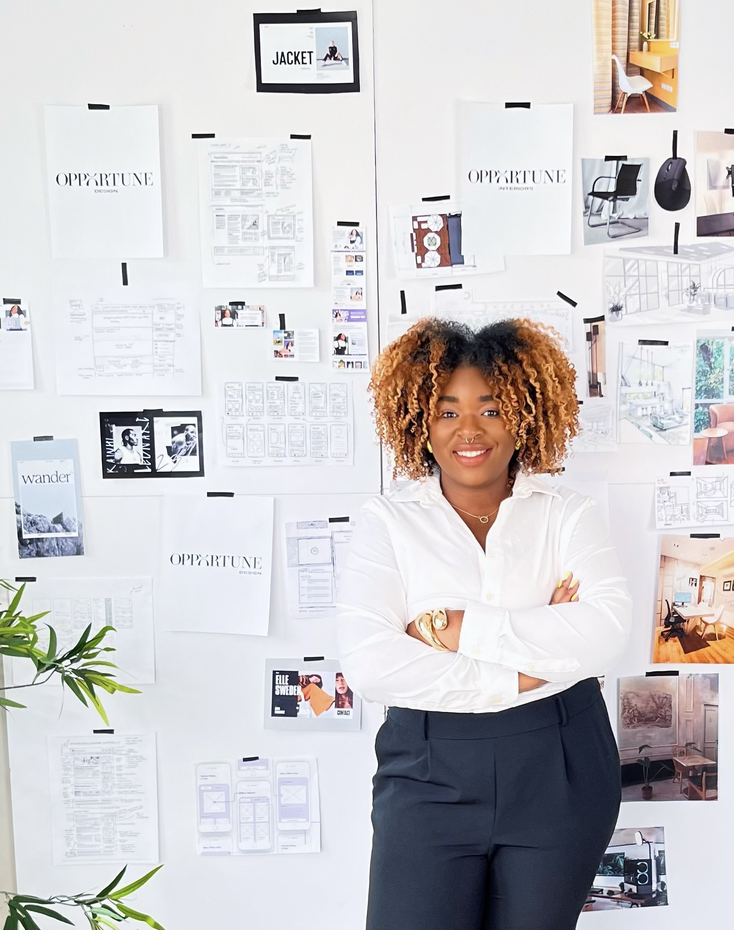 A woman standing in front of a wall covered in papers