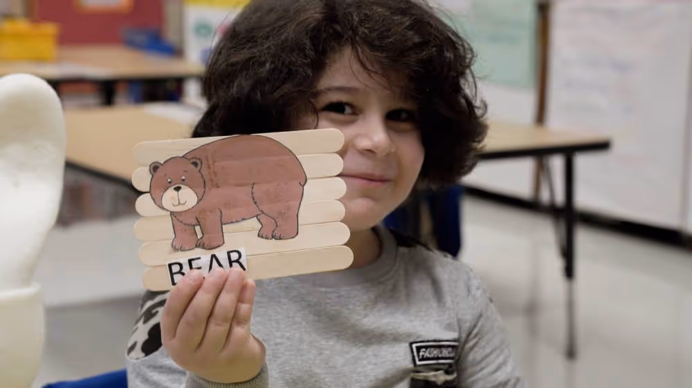 Child holding bear craft