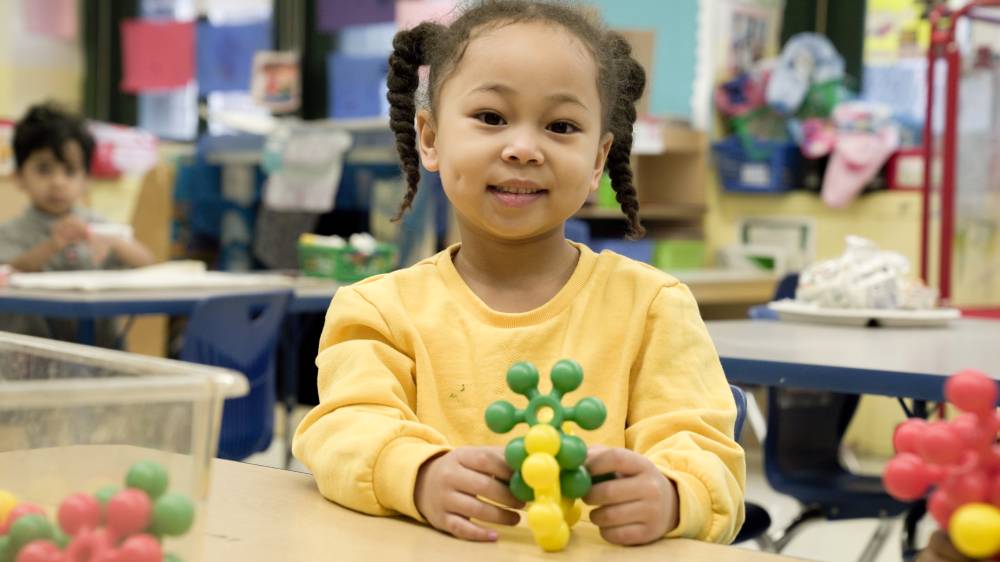 Girl holding toy blocks
