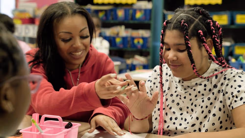 Teacher helping student activity
