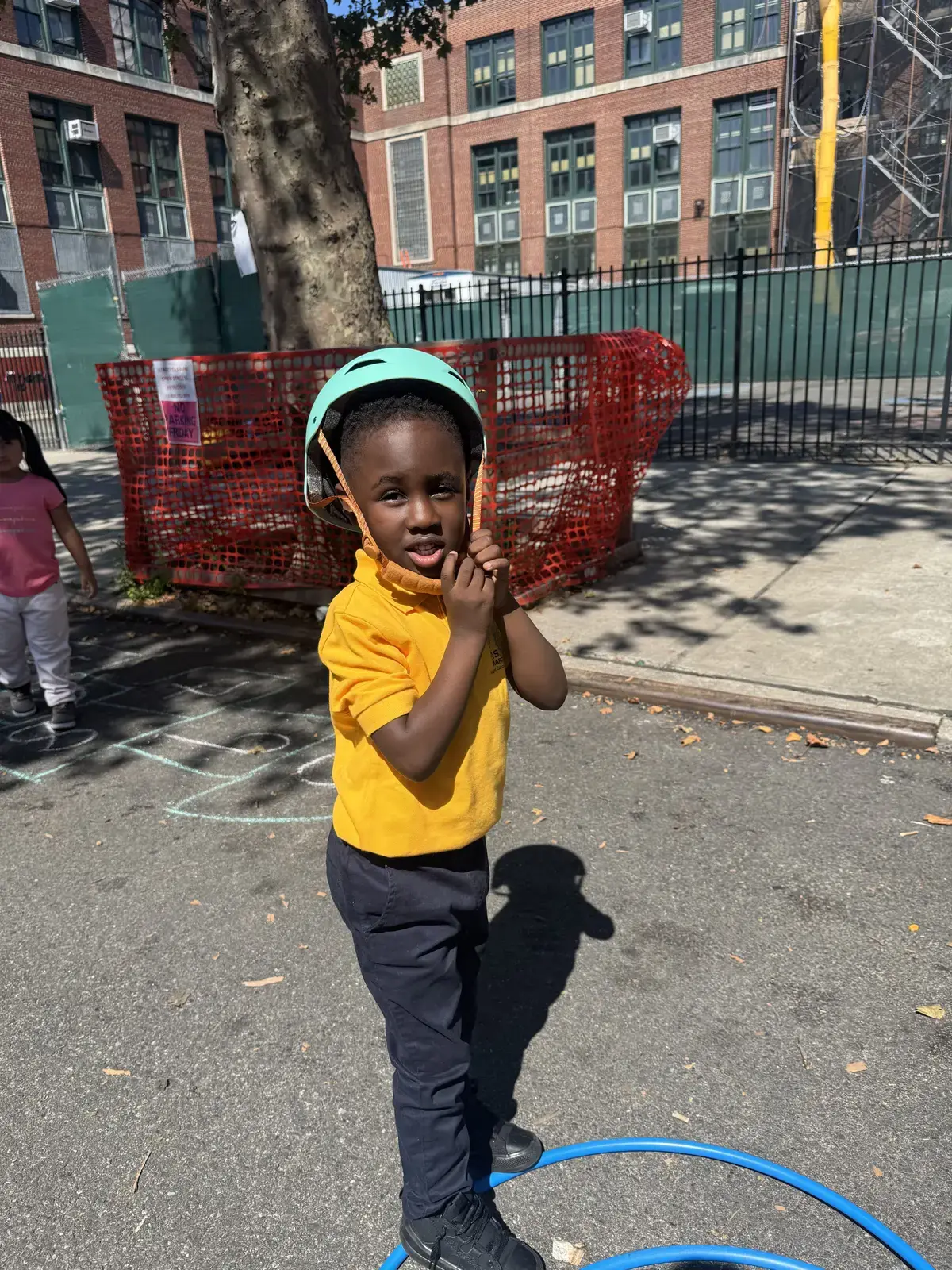 Student wearing helmet playing on school playground