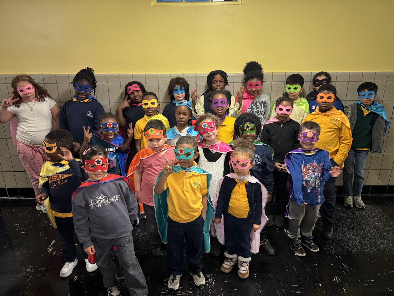 Students wearing colorful superhero masks and capes pose together