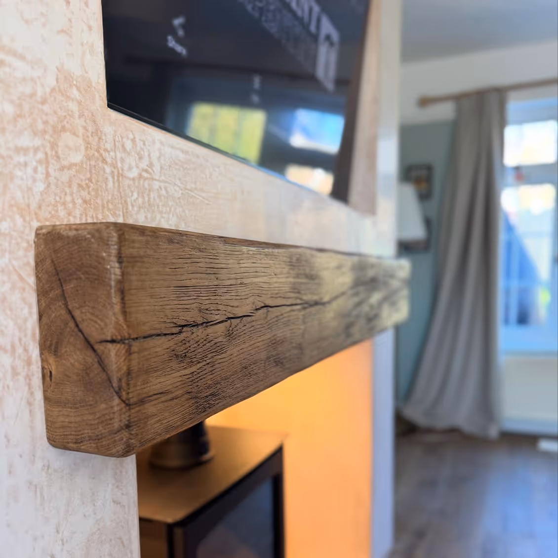 Wooden beam next to chimney breast.