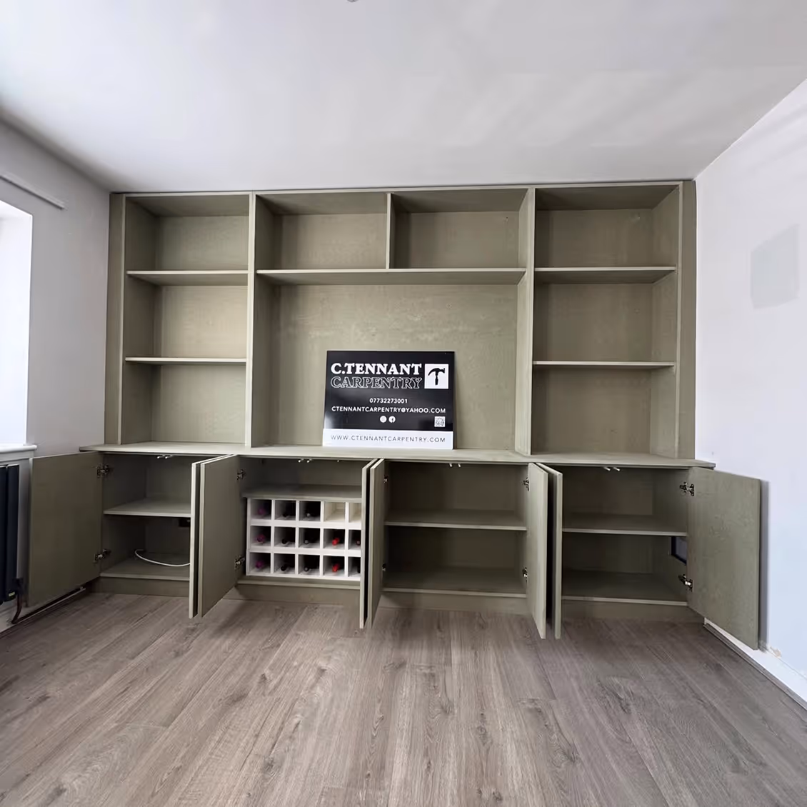 Finished media wall with cabinets open